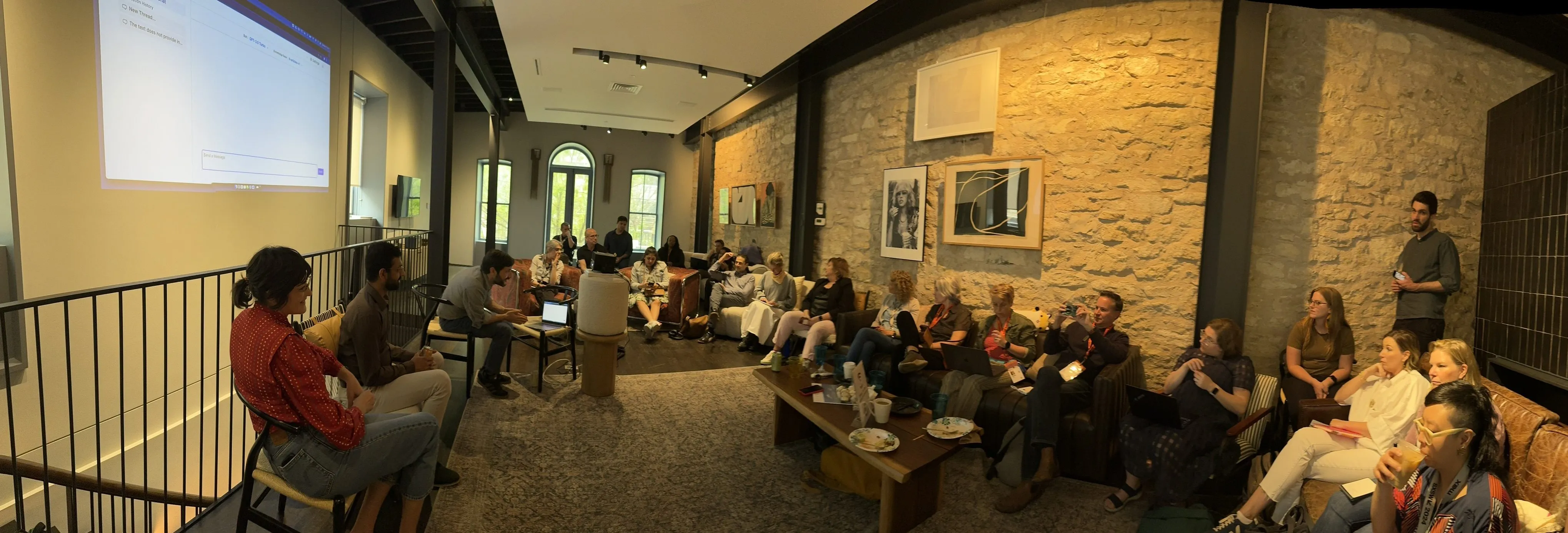 A group of more than 20 people are gathered for one of the discussions at the AI x Journalism House